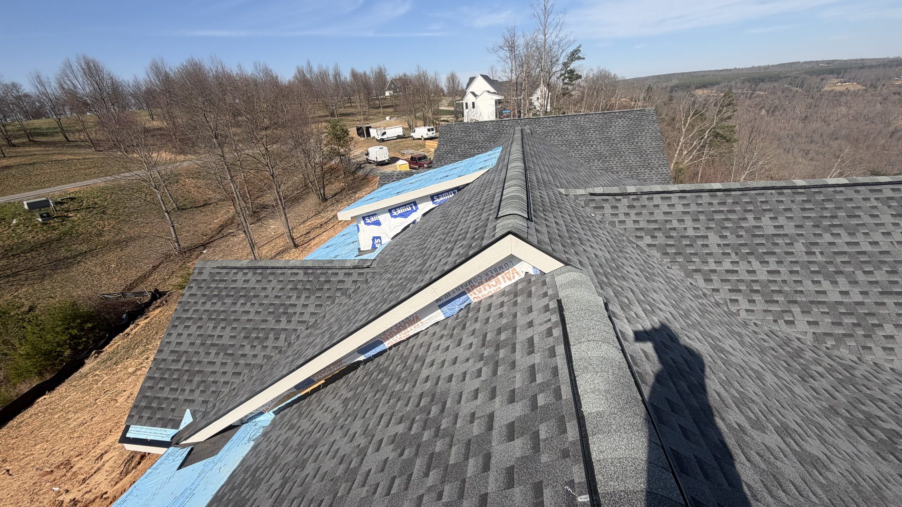 Aerial view of a freshly installed dimensional shingle roof on a Tennessee country home