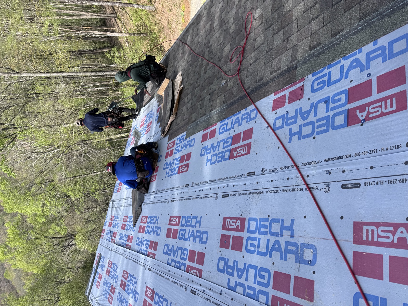 HB Contracting in-house crew installing new shingles