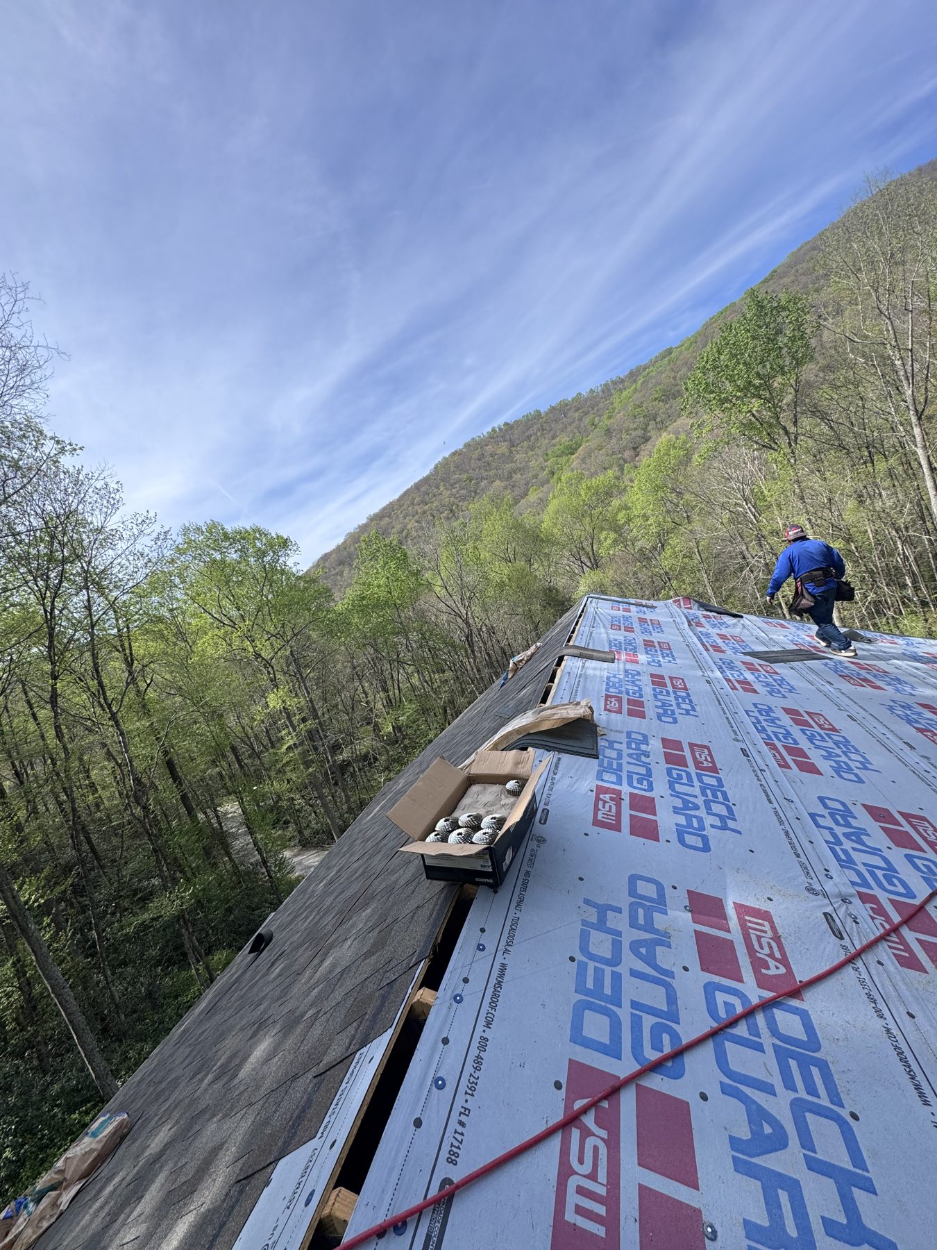 HB Contracting roofer working on a mountainside roof in Tennessee