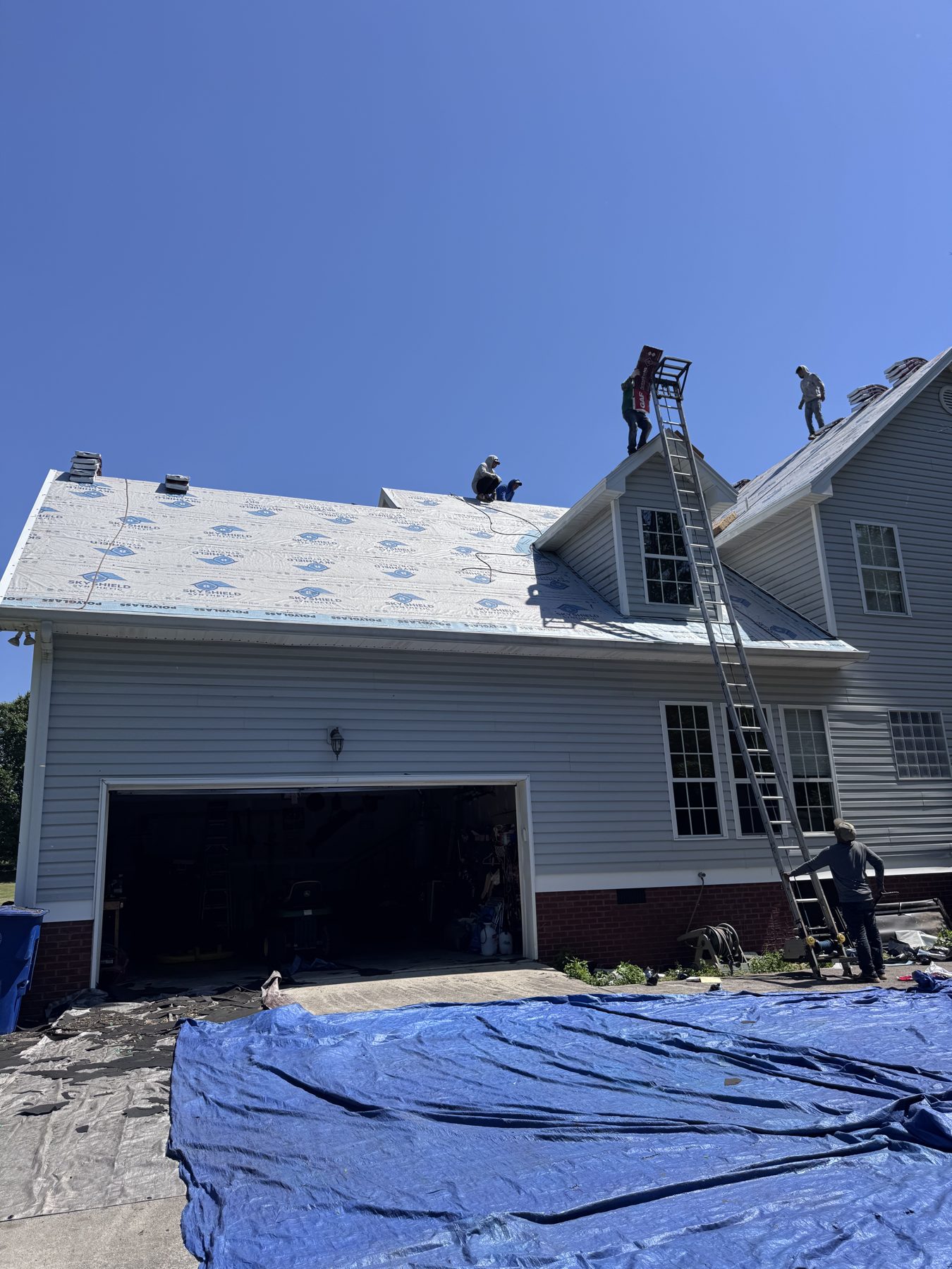 Full view of a residential roof replacement in progress with HB Contracting crew