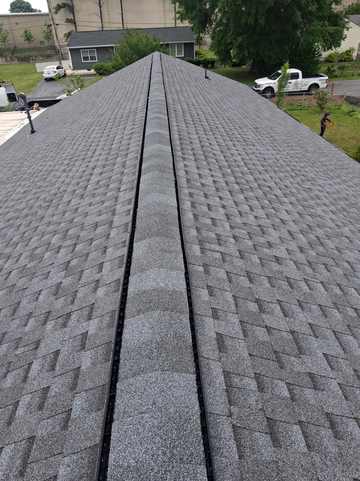 Finished asphalt shingle ridge view from the peak of a Chattanooga roof